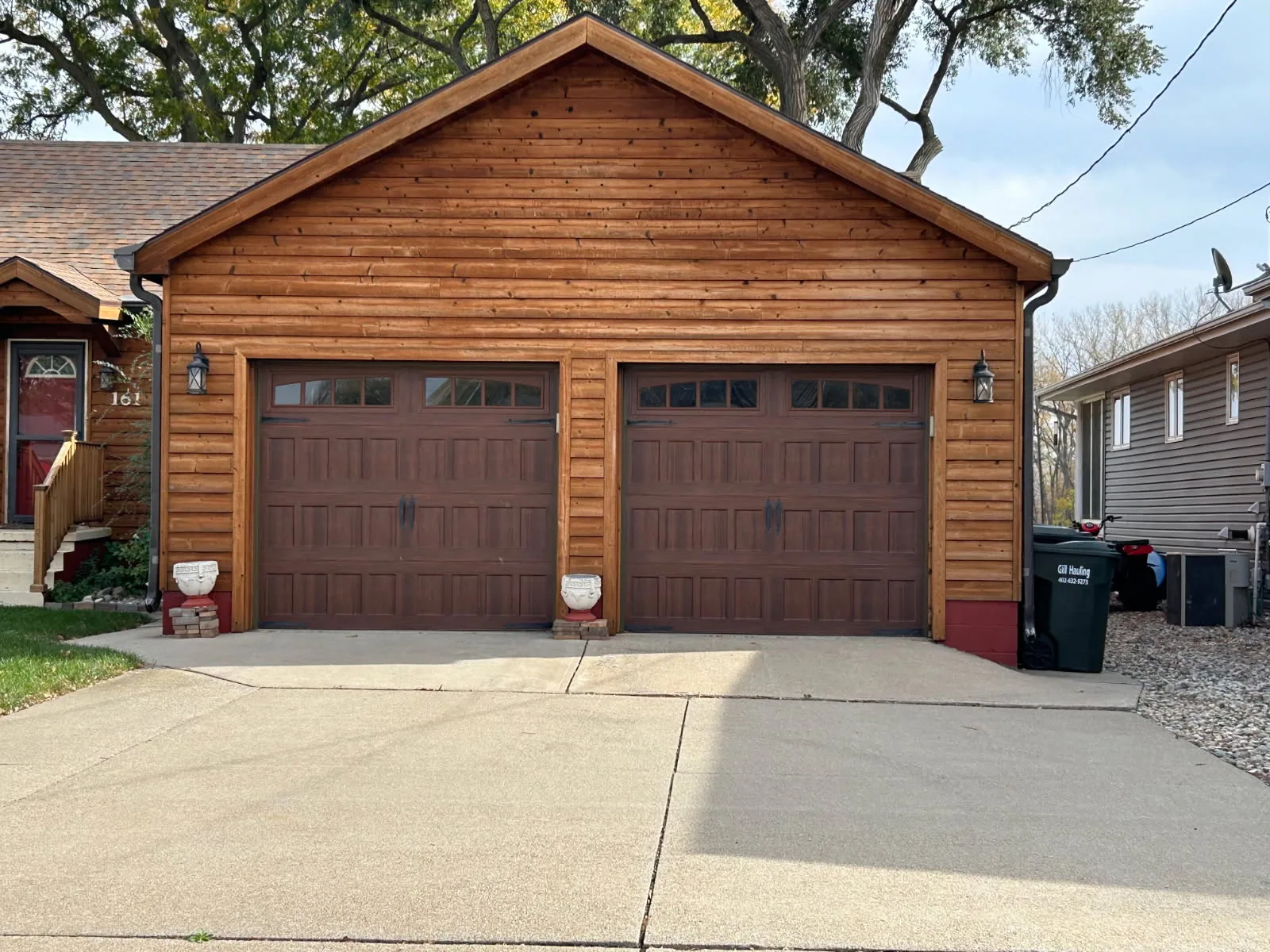 Carriage style garage door installation on log cabin home Sioux City