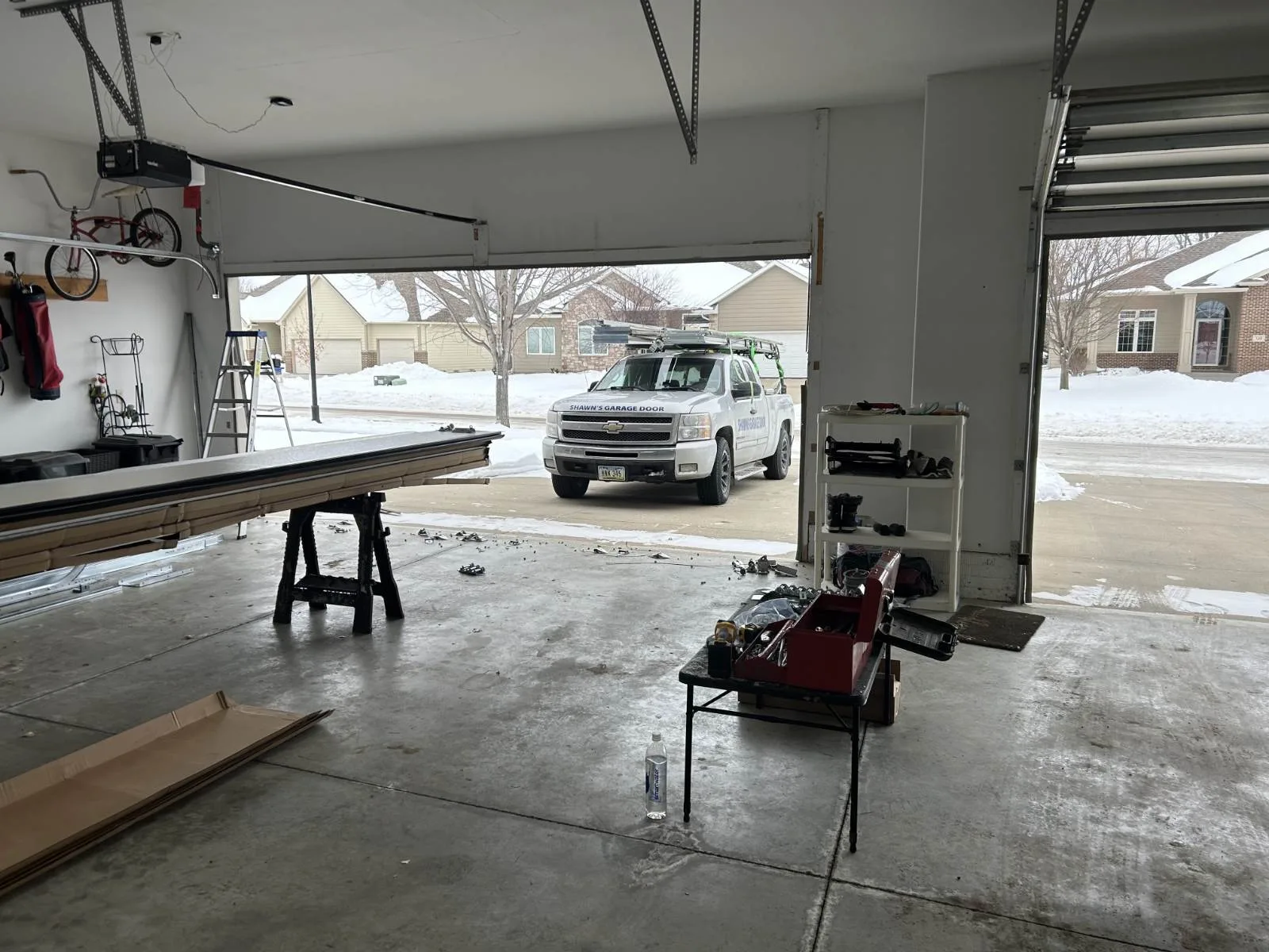 Commercial garage door installation with scissor lift