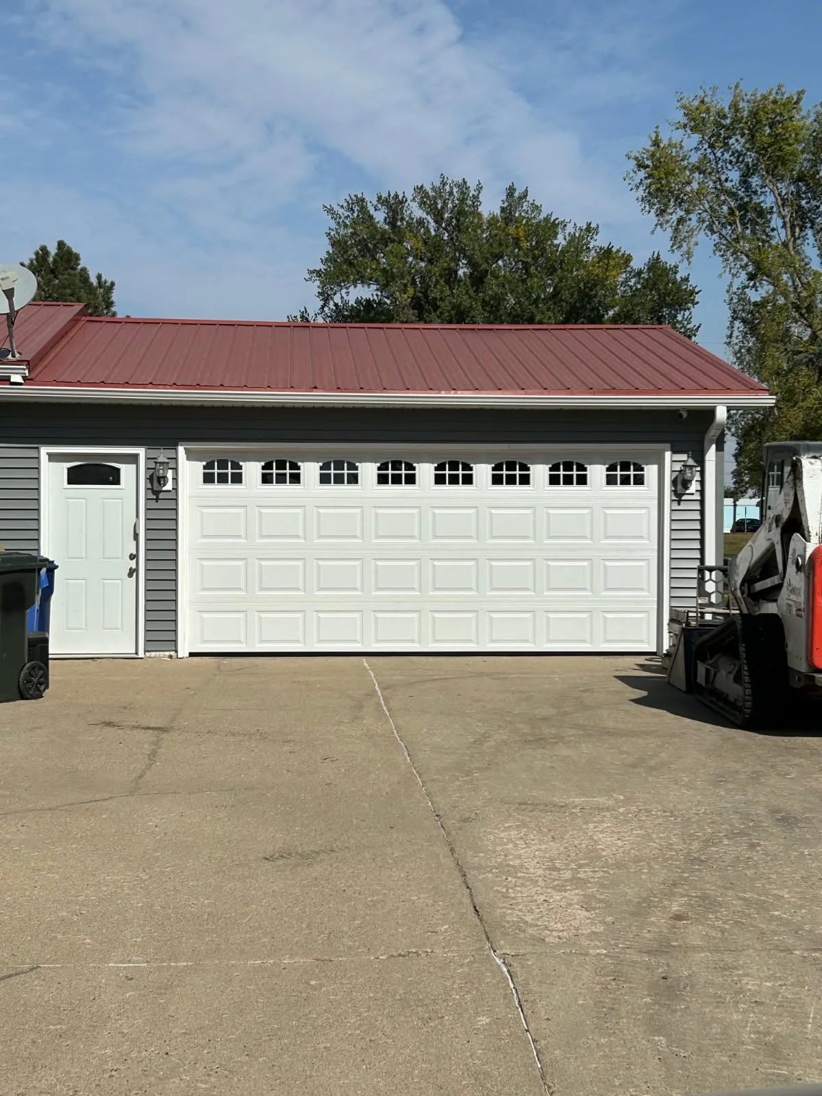 White traditional garage door with arch windows installation