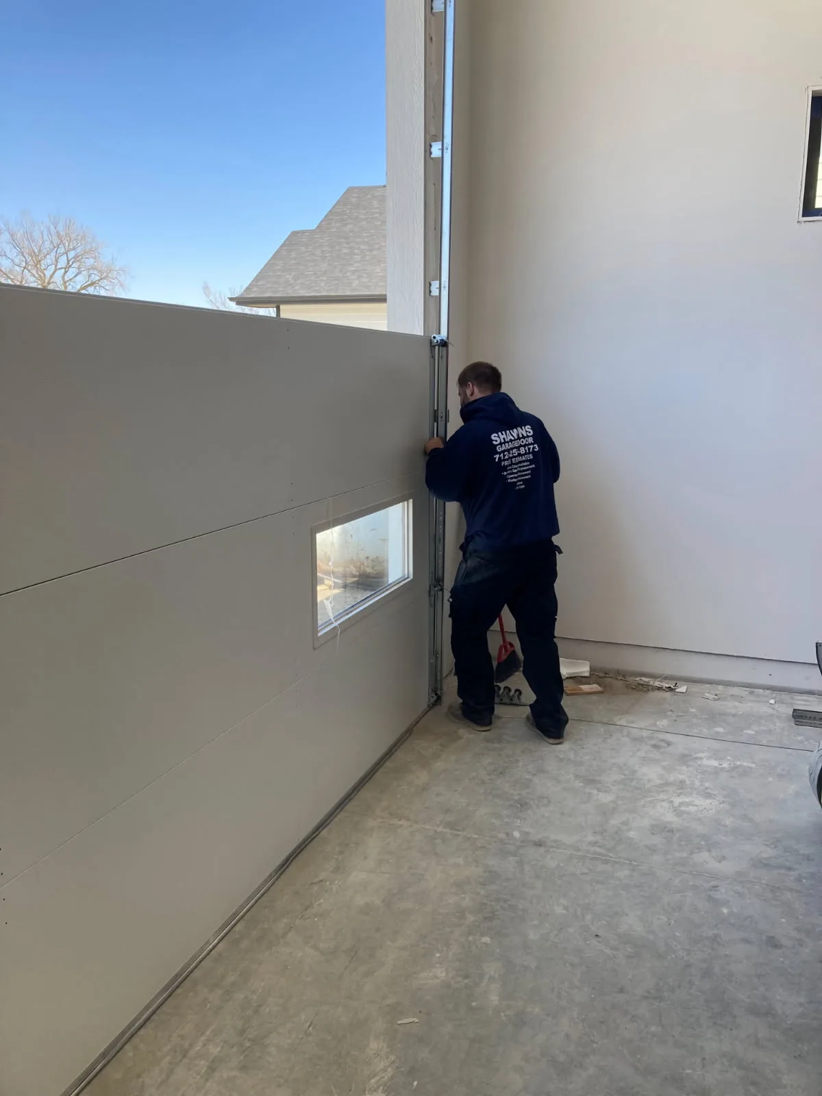 Shawn installing modern door on new construction